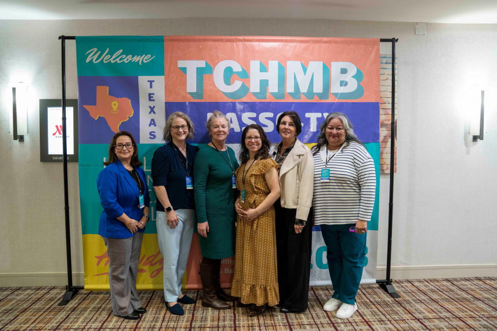 TCHMB speakers posing in front of banner.